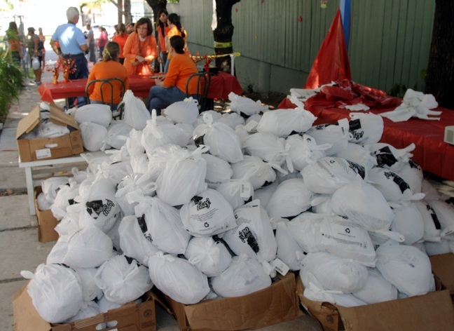 A pile of turkeys awaits distribution during the turkey giveaway Nov. 21 at St. John Bosco Church in Little Havana. In addition, Ceci's Pizza donated a slice of pizza to those waiting in line.