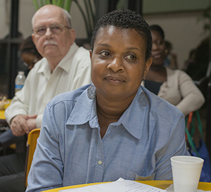 Daphne Dominique, assistant to the principal at Archbishop Curley Notre Dame Prep and youth minister at St. Martha Parish, listens to Robert McCarty.