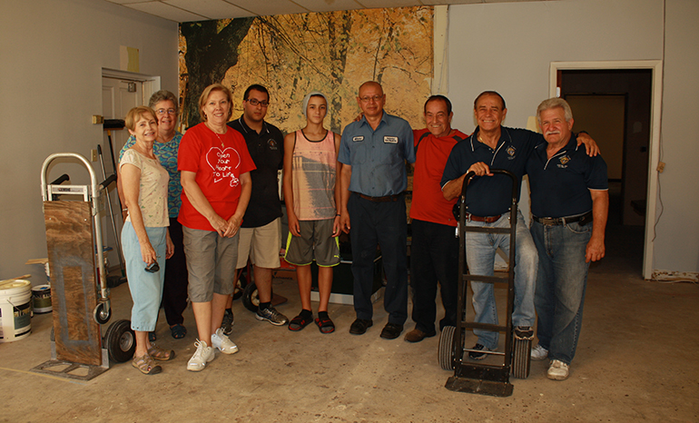 After taking time off from work to help unload a truck of ceramic tiles, members of the Knights of Columbus Council 14215, from Mother of Christ Parish in Miami, pose with respect life staff, from left: Barbara Groeber, director of education; Maureen Freeman, program coordinator for the South Broward Pregnancy Help Center; and Joan Crown, Respect Life director.