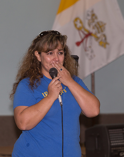 Alejandra Saucedo, of Dreamer's Moms, addresses Mass-goers at the reception that followed the Mass. The group works for justice and dignity for immigrants.