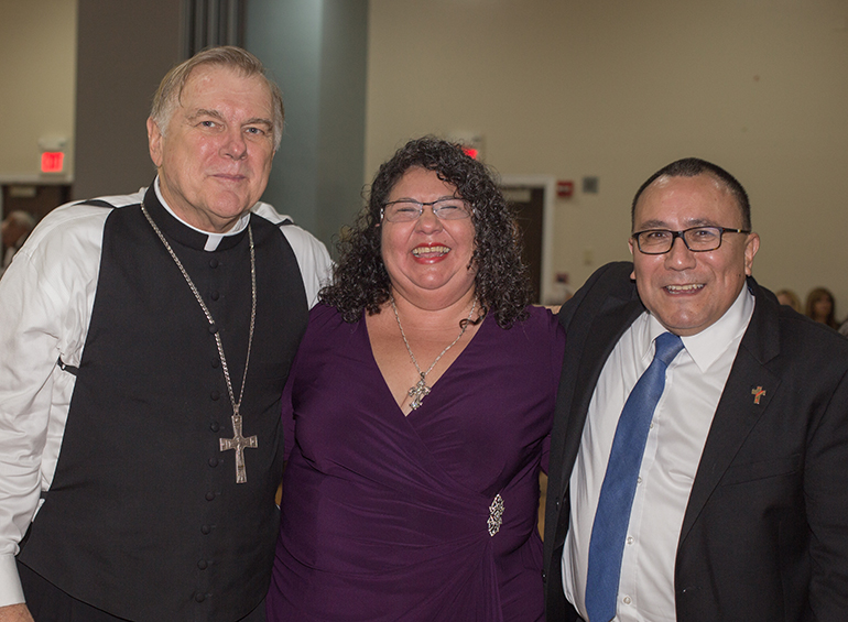 Archbishop Thomas Wenski poses for a photo after the Mass with Yraida Guanipa, a former inmate who founded the Yraida Guanipa Institute to keep a connection between inmates and their children, and Deacon Edgardo Farias, director of the archdiocesan Detention Ministry.