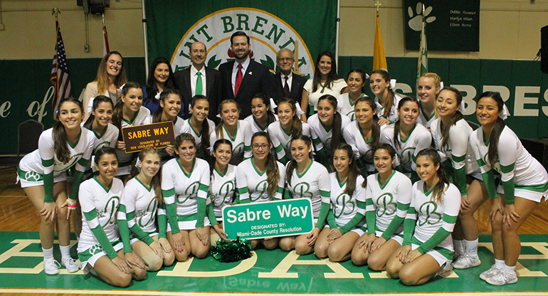 St. Brendan High cheerleaders, who performed at the street renaming celebration, pose with school and community officials after the ceremony.