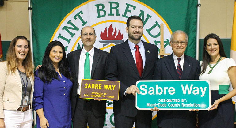 Posing with the Sabre Way sign, from left: St. Brendan Assistant Principal Barbara Acosta, Doral Vice Mayor Christi Fraga, St. Brendan Principal Jose Rodelgo-Bueno, Florida State Rep. Jose Felix Diaz, Miami-Dade Commisioner Javier Souto and Florida State Sen. Anitere Flores. Diaz and Fraga are school alumni.