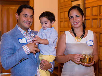Miami Catholic Medical Guild member Dr. Julio Barcena holds his son, Santiago, 2, as he and his wife, Carolina prepare to bring up the offertory.