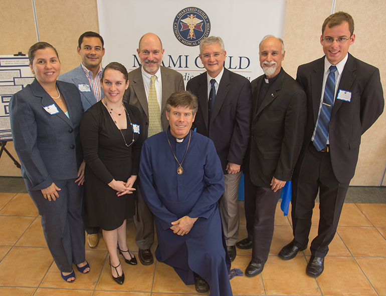 Leaders of the newly created Miami Guild of the Catholic Medical Association pose for a photo after Mass. From left: Dr. Marina Matute Obispo, pediatrician, representative for women in health care; Dr. Julio Barcena, cardiologist, guild treasurer; Victoria Faucheux, R.N., representative for health care professionals; Dr. Norman Ruiz Castaneda, pediatrician and permanent deacon at Epiphany Parish, guild secretary; Father Scott Francis Binet, M.D., guild president; Dr. Jose Martinez, cardiologist, guild vice-president; Father Alfred Cioffi, guild chaplain; and Aaron Patzwohl, UM medical student, representing medical students.