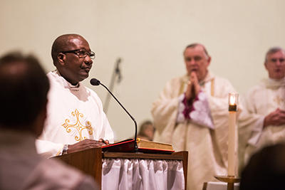Father Kidney M. St. Jean, pastor of Our Lady Queen of Heaven Parish in Fort Lauderdale, reads the Gospel during the 40th anniversary Mass and celebration for the parish, held Oct. 22.