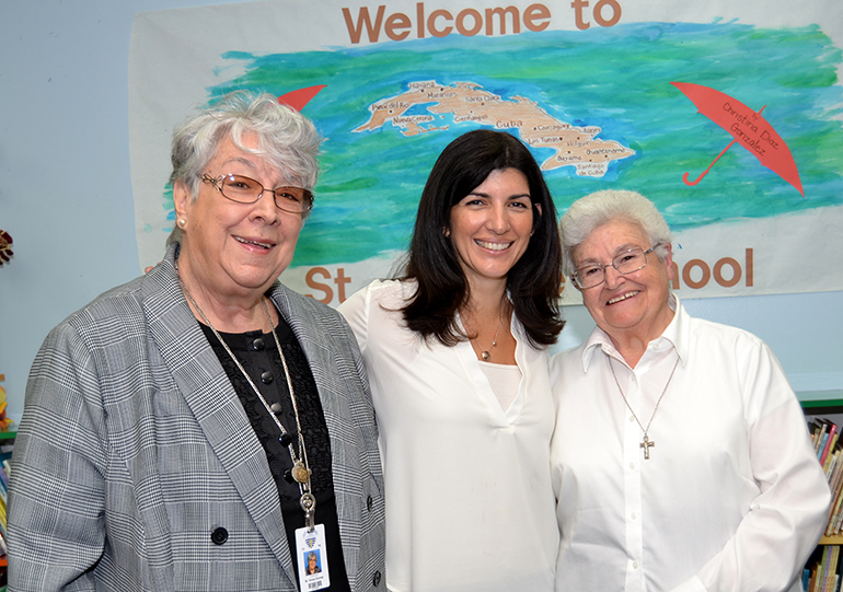 Christina Gonzalez, middle, visits with two Sisters of St. Philip Neri at St. Jerome School. They are Sister Vivian Gomez, the principal, left; and Sister Maria Victoria, right.