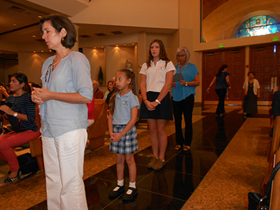 Nydia Claudio, St. Bonaventure's principal, leads the living rosary along with school children and staff.