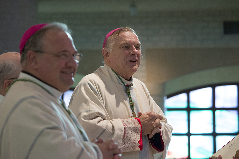 Archbishop Thomas Wenski,  with Auxiliary Bishop Peter Baldacchino at left, greets the nearly 1,200 religion teachers - catechists - from parishes and schools throughout the archdiocese who gathered for their annual Catechetical Conference Oct. 25 at St. Mark Church and Archbishop Edward McCarthy High School next door.
