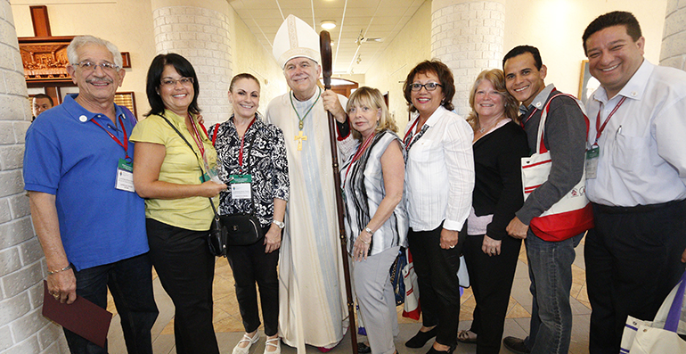 Archbishop Thomas Wenski poses with the Our Lady of Lourdes confirmation team, winners of this year's Esperanza Ginoris award for excellence in catechesis, in recognition of their innovative Spirit Day retreat for teens.