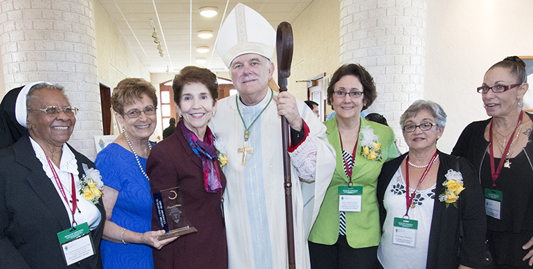 Archbishop Thomas Wenski poses with the winners of this year's Lifetime Catechetical Leadership award, from left: Sister Clementina Givens, Regina Medina, Leyda Vazquez, Lydia Mayorga, Amparo Martinez and Nanette Salvatore-Willis, daughter of the late Lorraine Salvatore.