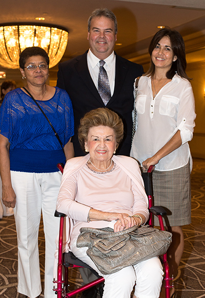 Dawn De Frietes, left, Paul Ludwick, Marie Ludwick, seated, and Darlene Ludwick were on hand for the first annual Women of Faith event. The Archdiocese of Miami honored Marie Ludwick and nine other outstanding women from across South Florida for their work, dedication and commitment to the Catholic Church.