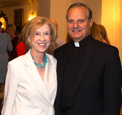 Winifred Amaturo and Msgr. Franklyn Casale, president of St. Thomas University in Miami, attend the first annual Women of Faith event.