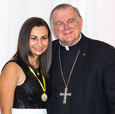 Christina Wells of Archbishop McCarthy High School in Southwest Ranches receives her Women of Faith award from Archbishop Thomas Wenski.
