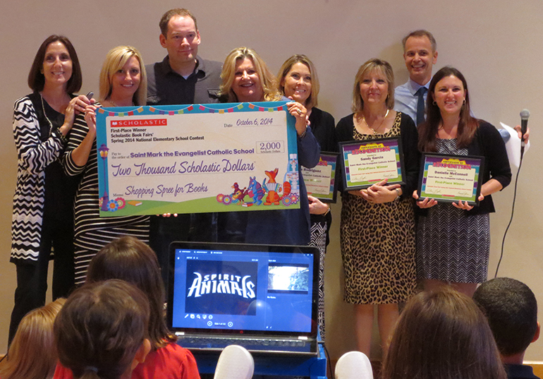 The Scholastic crew and author Brandon Mull present St. Mark's principal, Shirley Sandusky, center, with the first place prize. The library team, which includes Dana Rodriguez, Sandy Garcia, and Danielle McCulloch were also recognized.