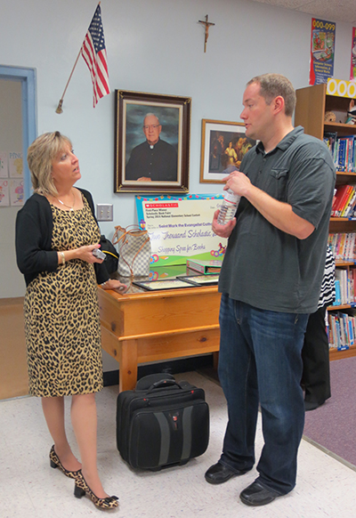 Author Brandon Mull and St. Mark's media specialist, Sandy Garcia, share a quick word on getting students excited about reading. Garcia has all of Mull's books in the library, so students were more than ready to ask him questions.
