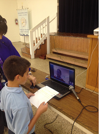 A Sts. Peter and Paul student asks a question of a Mexican student using the Skype app.
