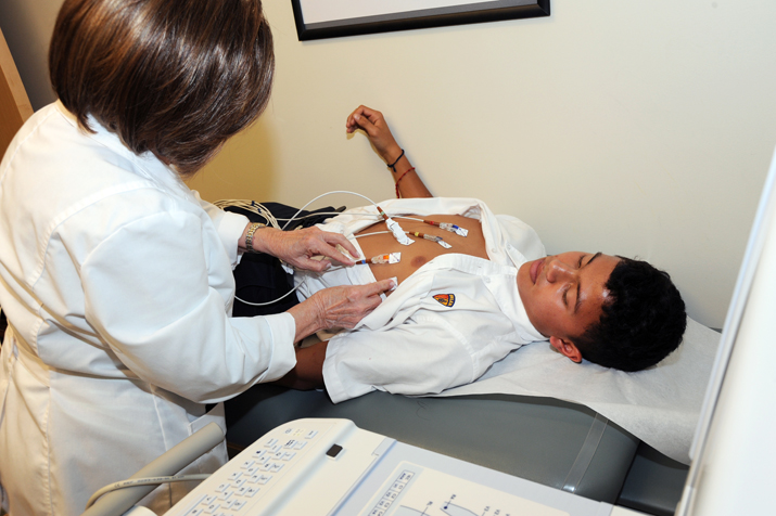A technician performs an EKG screening on Belen Jesuit freshman  Israel Lopez Morillo.