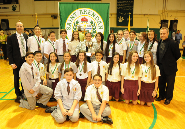 Posing with St. Timothy School's winning team are St. Brendan's principal, Jose Rodelgo-Bueno, president, Father Jose Alvarez (far right), and Annie Seiglie, St. Timothy's principal.