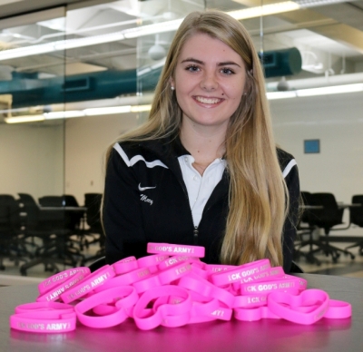 Mary Moran with a pile of wristbands for sale, as fundraisers for a brain cancer association.