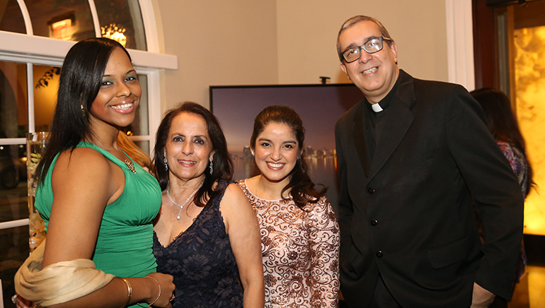 Michelle Diaz, left, a sponsor of the event, poses with Mirta Fuentes, executive director of the Leadership Center at St. John Bosco, Ruth Silva, a beneficiary of the Learning Center and now a student at Miami Dade College, and Father Arturo Kannel from St. John Bosco.