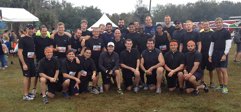 Seminarians and deacons from the Archdiocese of Miami pose with seminarians and deacons from around the state before competing in the Tough Mudder event. The rector/president of St. Vincent de Paul Regional Seminary, Msgr. David Toups, is fourth from left, kneeling.