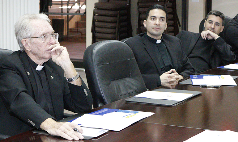 From left, Father Michael Hoyer, pastor of St. Gregory Church, Plantation, Father Jose Alfaro, pastor of Blessed Trinity Church, Miami Springs, and Father Manny Alvarez, pastor of Immaculate Conception, Hialeah, listen during the orientation session for implementation of the Synod pastoral plan.