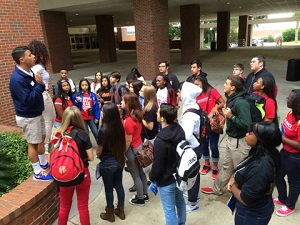 Msgr. Pace High School students listen to Pace class of 2013 alumnus Tommy Aponte (left) as he gives a tour of the University of Florida.