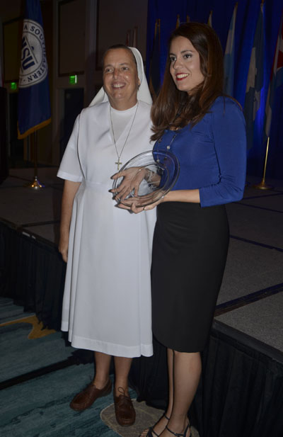 Sister Kim Keraitis, principal of Immaculata-La Salle High School, poses with computer graphics teacher Elena Capablanca after Capablanca was presented with the Cervantes Outstanding Educator Award.