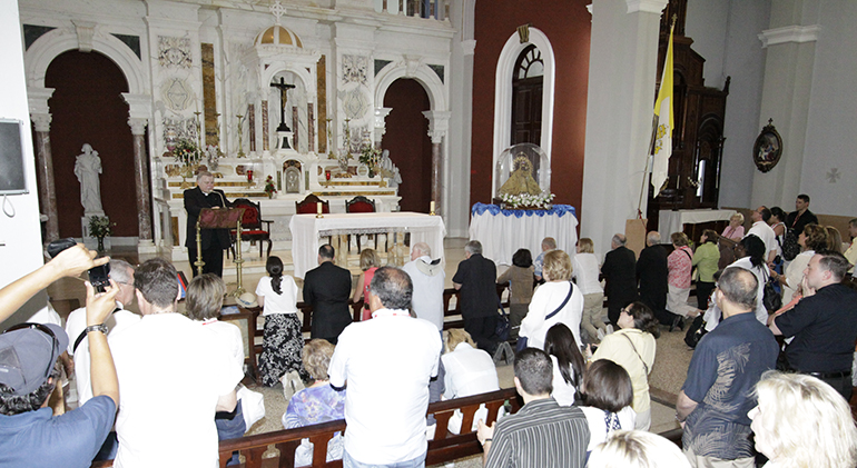 Archbishop Thomas Wenski leads the pilgrims in prayer at the Shrine of Our Lady of Charity in El Cobre, Cuba, in March 2012. He said to invoke Our Lady's intercession for three things: the pilgrims, the U.S., and Cuba. Both the Cuban and U.S. governments welcomed the role played by Pope Francis, through Havana's Cardinal Jaime Ortega, in the dialogue that resulted in today's announcement of an easing of tensions between the two countries.