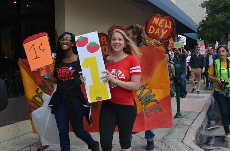 Quayneshia Smith, left, and Joleaha Dotter, sophomores at Barry University, take part in the march for farmworkers' rights.