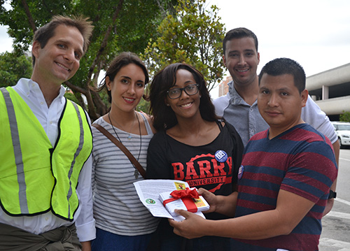 Showing the petition they would later present to a Publix manager, from left, Anthony Vinciguerra, of St. Thomas University's Center for Community Engagement, Paulina Sicius, a student at St. Thomas, Quayneshia Smith, a student at Barry University, Luis Castro, a student at FIU, and Cruz Salucio of the Coalition of Immokalee Workers.