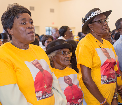Paula Louis, Marie Detin and Liza Fauquet wear Cardinal Chibly Langlois T-shirts during the Mass he celebrated at Notre Dame d'Haiti Mission in Miami.