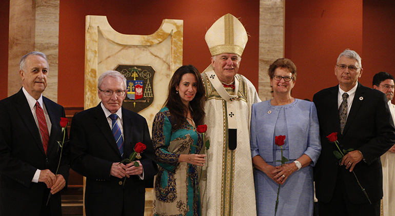 Newly-inducted members of the Archbishop Coleman Carroll Legacy Society pose for a photo with Archbishop Thomas Wenski; from left: Salvatore Difede, John Dietl, Smilka Meldoza representing Vivian Decker, a posthumous honoree, and Kevin and Sandra Davis.