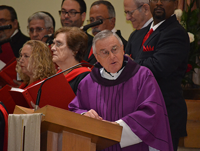 Father Juan Lopez, pastor of Sts. Peter and Paul, delivers a few remarks at the end of the 75th anniversary Mass.