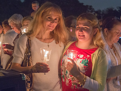 Dec. 1, 2014
MARLENE QUARONI | FC
Andrea Puleo and her daughter, Angelica, 16, hold candles during the blessing ceremony for the life-size nativity scene on display outside the Little Flower Church, Coral Gables.