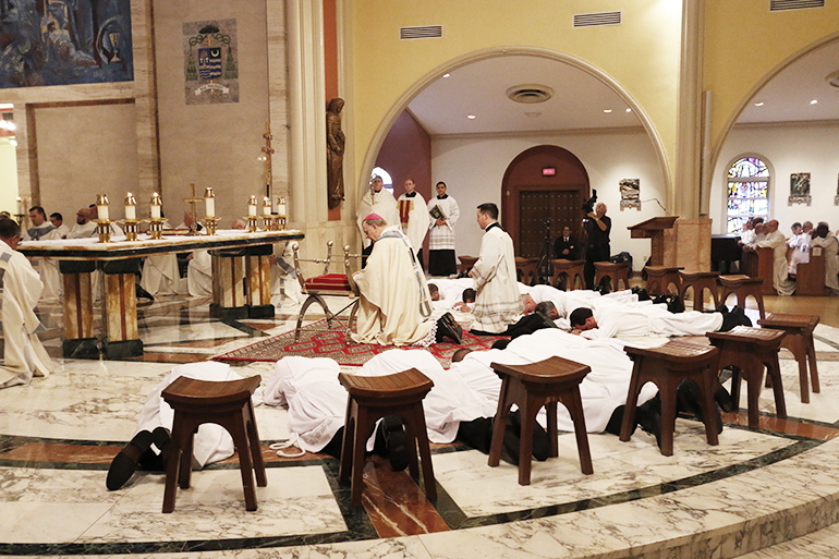 Before a standing-room only cathedral filled with their wives, children and friends, Archbishop Thomas Wenski ordained 13 men as permanent deacons for the Archdiocese of Miami.