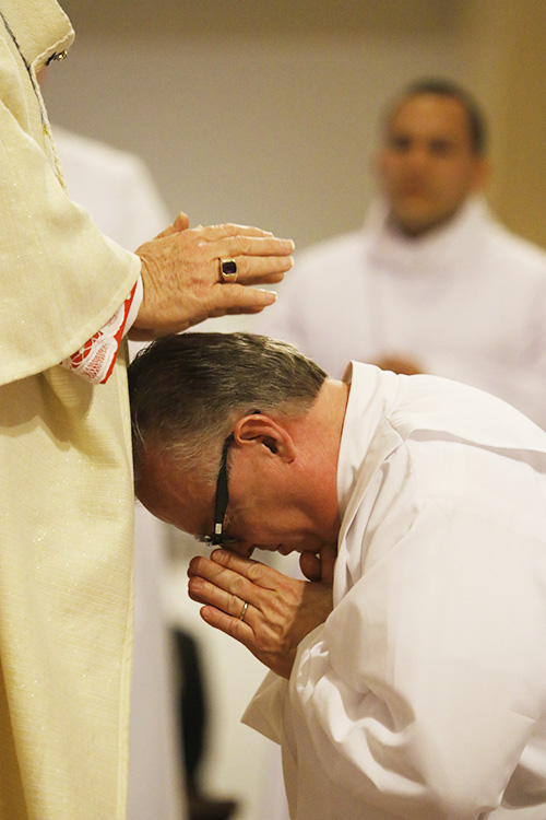 Archbishop Thomas Wenski ordains Deacon Jose Felipe Gomez, one of 13 new permanent deacons for the Archdiocese of Miami.