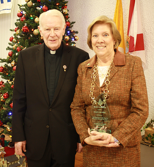 Archdiocesan Respect Life Director Joan Crown receives the annual John Paul II Award from St. Malachy's pastor, Father Dominic O'Dwyer.