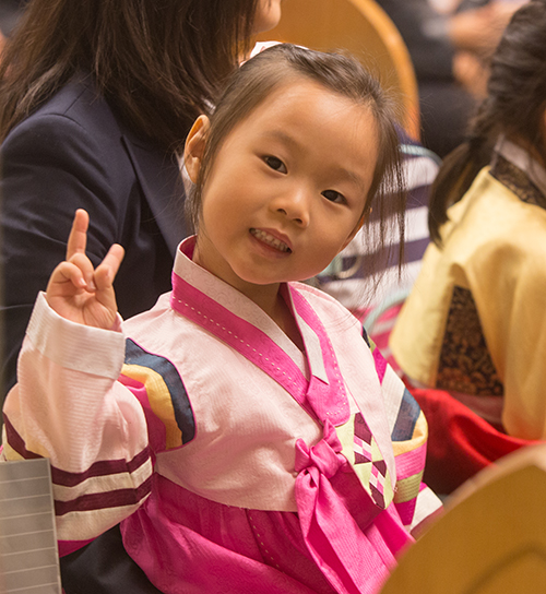 Jenna Kwon, 3, smiles as she makes the peace sign.