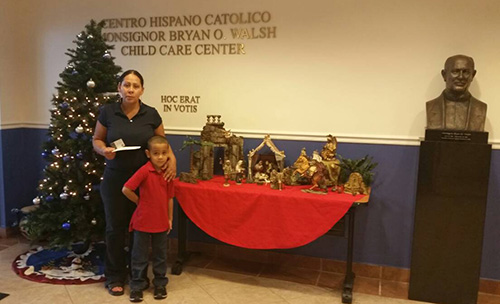 One of two recipients of a Heart of Christmas gift card poses with her son at Centro Hispano Catolico Child Care Center in Little Havana.