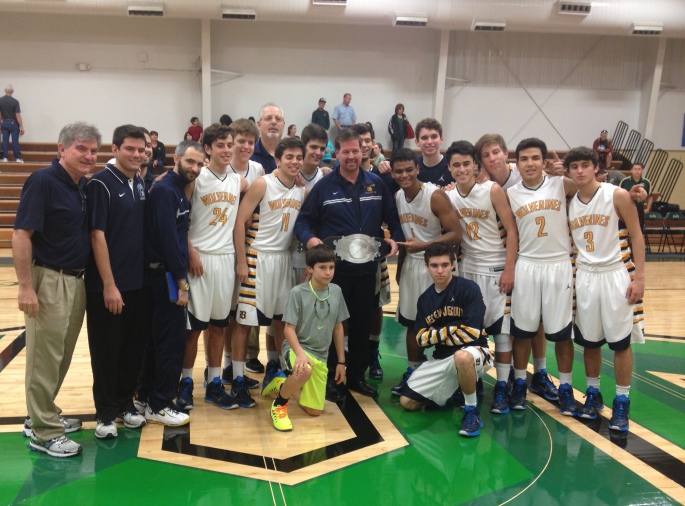 The 2014 Basketball Catholic State Champions Belen Jesuit Wolverines pose with their winning championship belt at the conclusion of the tournament held in St. Augustine, FL the weekend of December 19.