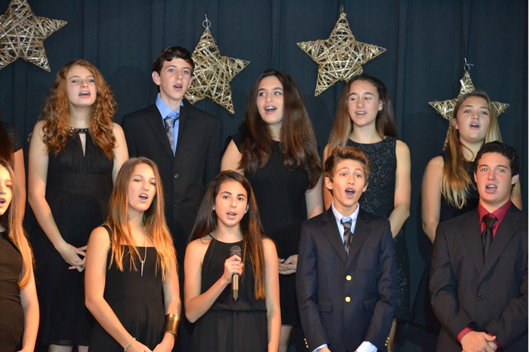 St. Agnes Middle School students help spread the holiday spirit as they sing Christmas carols. The singing was part of the annual Advent show. Students also recounted the Nativity story.