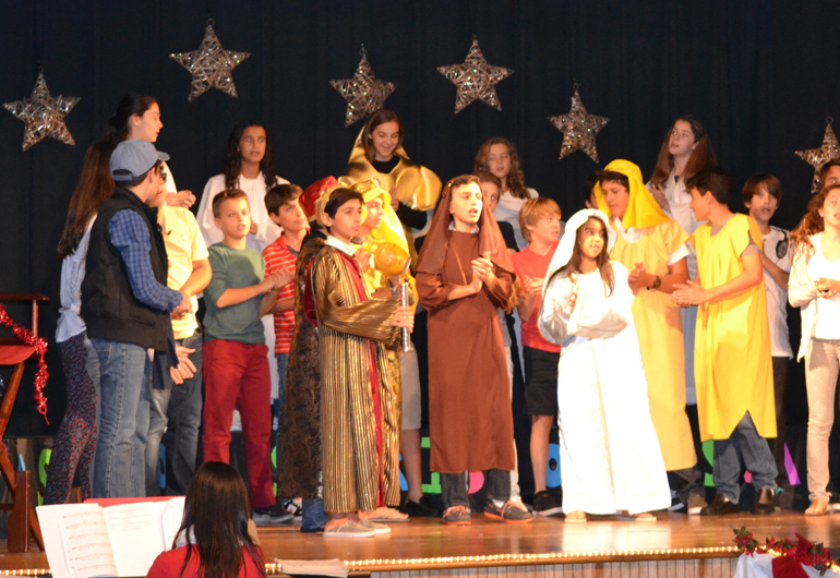 With a starry background, a group of shepherds, angels, and present-day students from St. Agnes Middle School perform their annual Advent show.   The Nativity story and Christmas carols helped spread the holiday cheer.