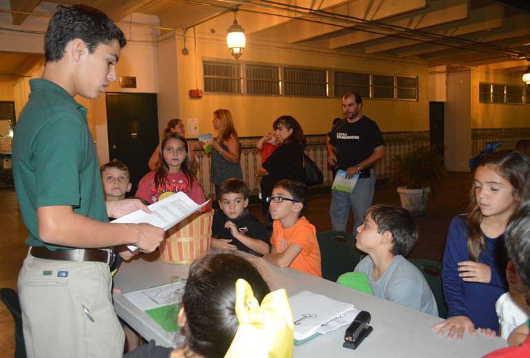 COURTESY PHOTO |

At the "Reading Under the Stars" event at St. Kevin School, eighth graders led "I am Happy" book activities presented in the illustrated children's book by the same name, whose author is St. Kevin School teacher Carlota Fernandez.