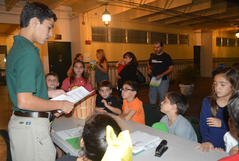 COURTESY PHOTO |
At the "Reading Under the Stars" event at St. Kevin School, eighth graders led "I am Happy" book activities presented in the illustrated children's book by the same name, whose author is St. Kevin School teacher Carlota Fernandez.