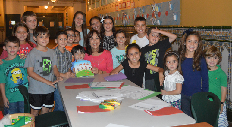 COURTESY PHOTO |
St. Kevin School teacher Carlota Fernandez (sitting center) released "I am Happy," her illustrated children's book, which will aid parents in teaching the virtue of gratitude to children. The author and students paused for a quick photo together at the "Reading Under the Stars" event at St. Kevin School.