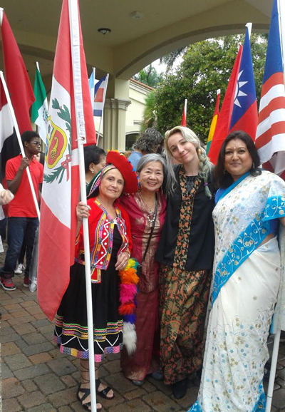 COURTESY PHOTO |

St. Gregory parishioners pose in their native garments and hold their flags as they wait for the parade of flags to start.