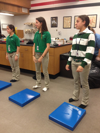 St. Brendan students Katia Sierra, Daniella Piloto and Victoria Lara volunteered to demonstrate what types of tests are done for concussions during St. Brendan High Medical Academy's recent visit to Barry University's School of Human Performance and Leisure Sciences.