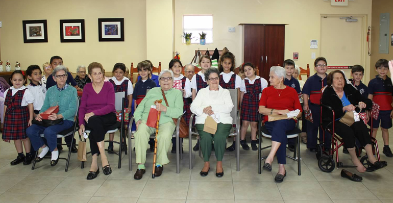 St. Brendan Elementary students visited the Senior Center in Westchester to bring holiday cheer through singing, crafting, and gift giving.